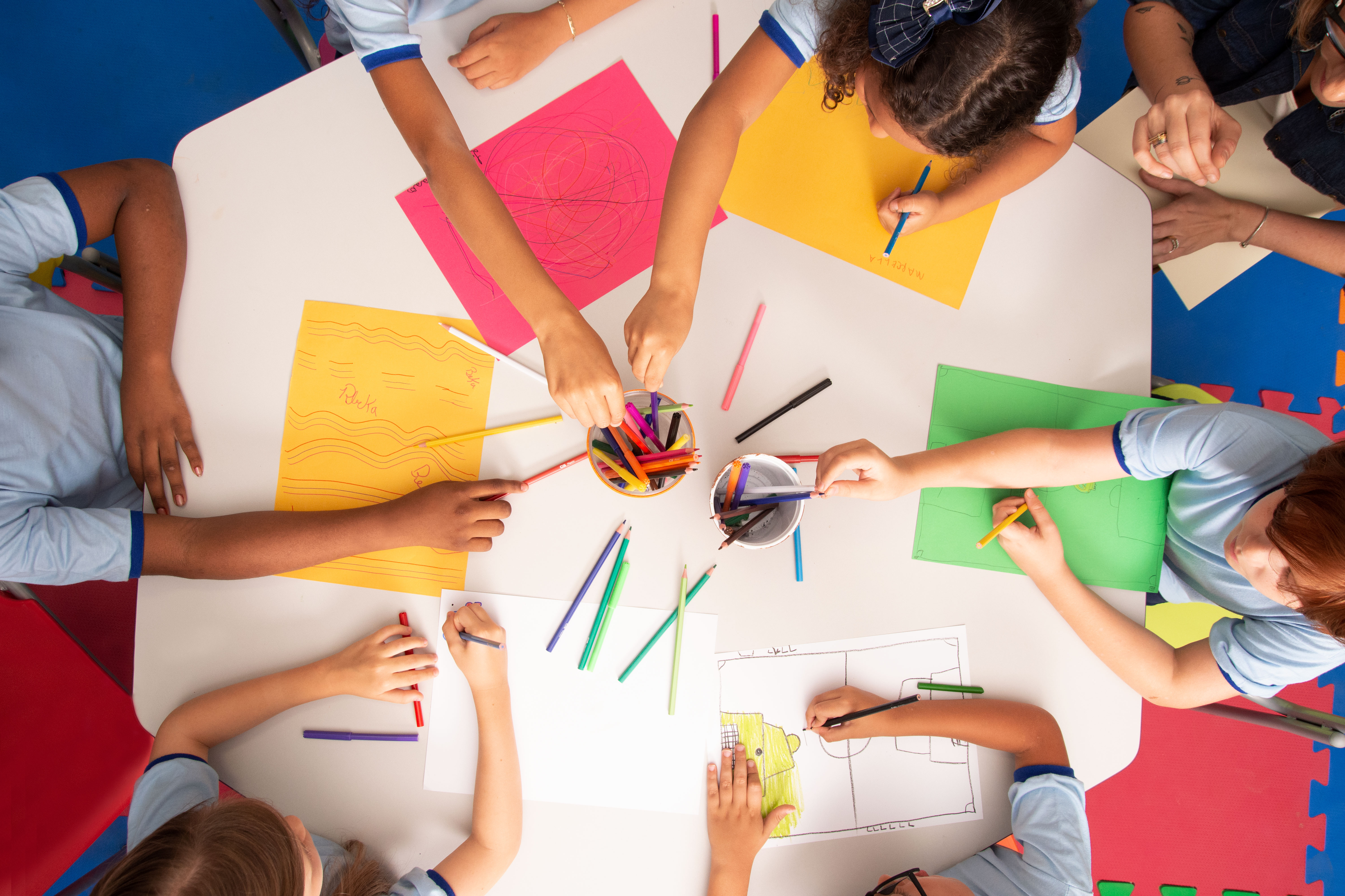 Children drawing with colorful pencils in art class